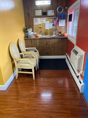 a waiting room with two chairs and a counter at Scottish Inns Wrightstown in Wrightstown