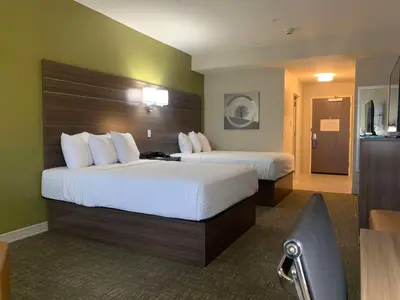 a hotel room with two beds and a chair at Best Western Plus Horseheads - Elmira in Horseheads
