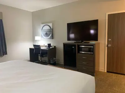 a hotel room with a bed and a flat screen tv at Best Western Plus Horseheads - Elmira in Horseheads