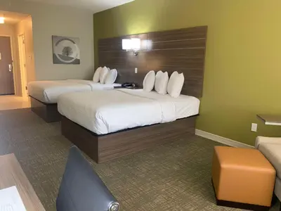a hotel room with two beds and a couch at Best Western Plus Horseheads - Elmira in Horseheads