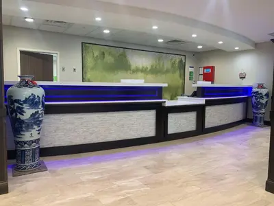 a lobby with a counter with two vases at Best Western Plus Horseheads - Elmira in Horseheads