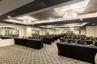 a banquet hall with black tables and chairs at The Hub Murray Hill, BW Premier Collection in New Providence