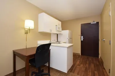 a small kitchen with a desk and a refrigerator at Extended Stay America Suites - Philadelphia - Mt Laurel - Crawford Place in Mount Laurel