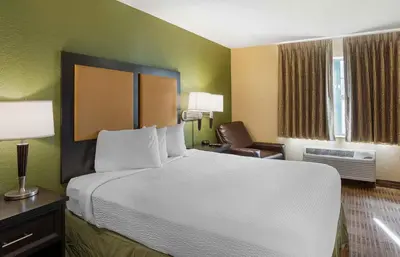 a hotel room with a large bed and a chair at Extended Stay America Suites - Philadelphia - Mt Laurel - Crawford Place in Mount Laurel