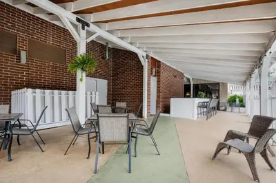 a patio with tables and chairs and a brick wall at Best Western Plus Wilkes Barre Center City in Wilkes-Barre