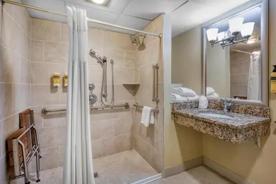 a bathroom with a shower and a sink at Best Western Plus Wilkes Barre Center City in Wilkes-Barre