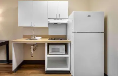 a kitchen with a white refrigerator and a counter with a microwave at Extended Stay America Suites - Philadelphia - Cherry Hill in Maple Shade