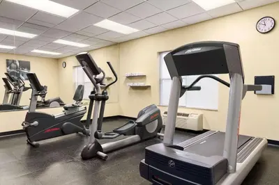 a gym with several tread machines in a room at Country Inn & Suites by Radisson, Frackville (Pottsville), PA in Mount Pleasant
