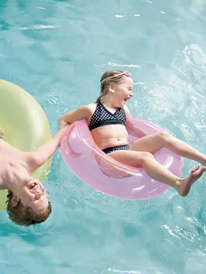 a young girl in a raft in a swimming pool at Country Inn & Suites by Radisson, Frackville (Pottsville), PA in Mount Pleasant