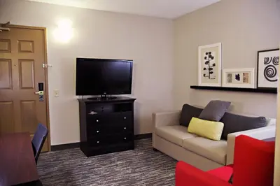 a living room with a couch and a flat screen tv at Country Inn & Suites by Radisson, Frackville (Pottsville), PA in Mount Pleasant