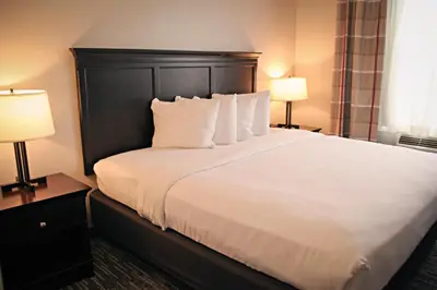 a bedroom with a large white bed with two lamps at Country Inn & Suites by Radisson, Frackville (Pottsville), PA in Mount Pleasant