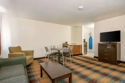 a living room with a couch a table and a tv at Quality Inn Bloomsburg in Bloomsburg