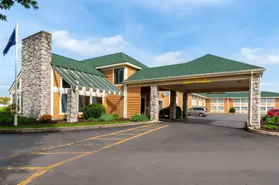 a large building with a parking lot in front of it at Quality Inn Bloomsburg in Bloomsburg