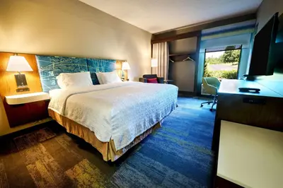 a hotel room with a bed and a television at Hampton Inn Flemington in Flemington