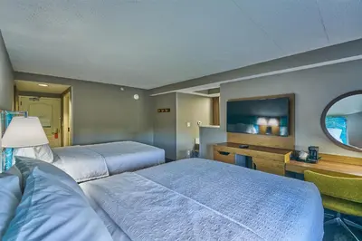 a hotel room with two beds and a television at Hampton Inn Flemington in Flemington