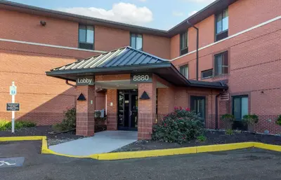 a red brick building with a entrance to a building at Extended Stay America Suites - Philadelphia - Airport - Bartram Ave in Philadelphia