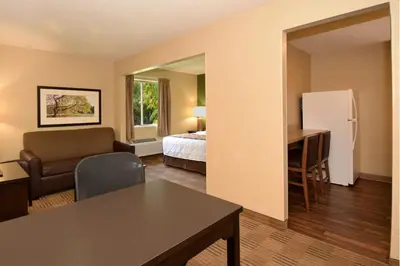 a living room with a bed and a desk in a room at Extended Stay America Suites - Philadelphia - Airport - Bartram Ave in Philadelphia