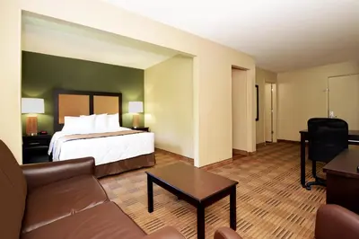 a hotel room with a bed and a couch at Extended Stay America Suites - Philadelphia - Airport - Bartram Ave in Philadelphia