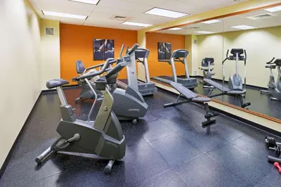 a gym with a row of exercise bikes in a room at Country Inn & Suites by Radisson, Lewisburg, PA in Lewisburg
