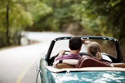 a man and a woman riding in a car at Country Inn & Suites by Radisson, Lewisburg, PA in Lewisburg