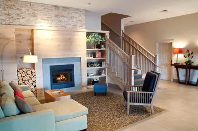 a living room with a couch and a fireplace at Country Inn & Suites by Radisson, Lewisburg, PA in Lewisburg