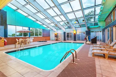 a swimming pool with a glass ceiling at Days Inn by Wyndham Scranton PA in Dickson City