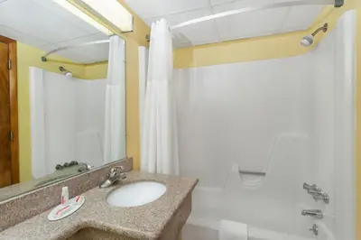 a bathroom with a sink and a shower at Days Inn by Wyndham Scranton PA in Dickson City