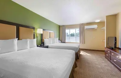 a hotel room with two beds and a television at Extended Stay America Suites - Philadelphia - Mt Laurel - Pacilli Place in Mount Laurel