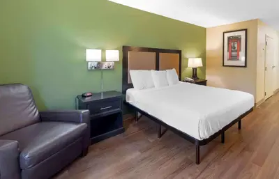 a bed and a couch in a room with a bed and a chair at Extended Stay America Suites - Philadelphia - Mt Laurel - Pacilli Place in Mount Laurel