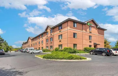 a large brick building with cars parked in a parking lot at Extended Stay America Suites - Philadelphia - Mt Laurel - Pacilli Place in Mount Laurel