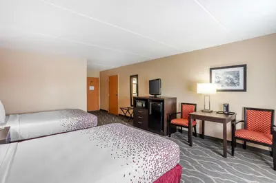 a hotel room with two beds a desk and two chairs at Best Western Inn at Blakeslee-Pocono in Blakeslee