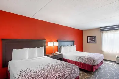 two beds in a hotel room with red walls at Best Western Inn at Blakeslee-Pocono in Blakeslee