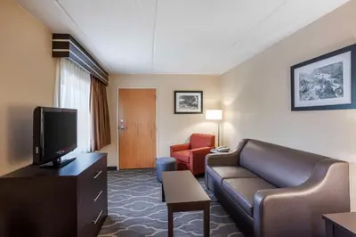 a hotel room with a couch and a television at Best Western Inn at Blakeslee-Pocono in Blakeslee