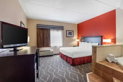 a hotel room with a bed and a flat screen tv at Best Western Inn at Blakeslee-Pocono in Blakeslee