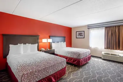 two beds in a hotel room with red walls at Best Western Inn at Blakeslee-Pocono in Blakeslee