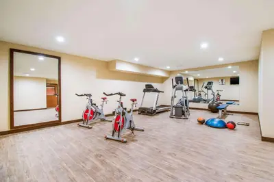 a gym with several exercise bikes and a mirror at Comfort Inn & Suites Harrisburg - Hershey West in Harrisburg