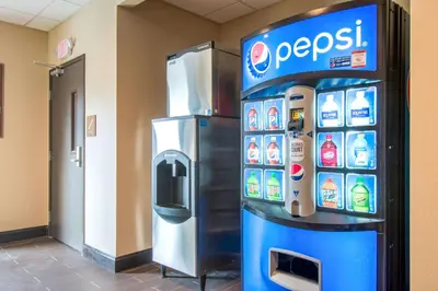 a pepsi machine in a building with a drink dispenser at Comfort Inn & Suites Harrisburg - Hershey West in Harrisburg