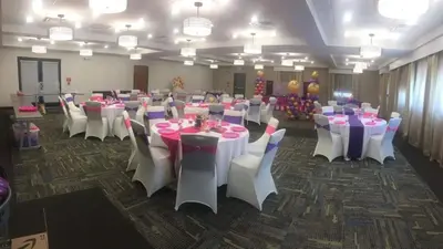 a banquet hall with white tables and white chairs at Holiday Inn Express Bordentown - Trenton South by IHG in Bordentown