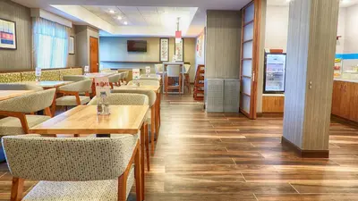 a dining room with wooden tables and chairs at Holiday Inn Express Bordentown - Trenton South by IHG in Bordentown