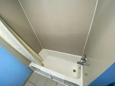 a shower stall in a bathroom with a toilet at Red Carpet Inn & Suites Wrightstown in Wrightstown
