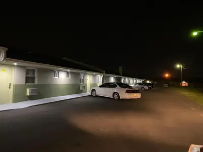 a car parked next to a building at night at Red Carpet Inn & Suites Wrightstown in Wrightstown