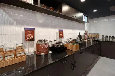 a kitchen with a counter with food on it at SpringHill Suites by Marriott New York Midtown Manhattan/Park Ave in New York