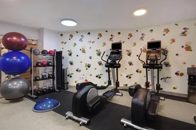 a gym with cardio equipment in a room with a wall at SpringHill Suites by Marriott New York Midtown Manhattan/Park Ave in New York