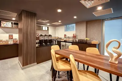 a dining room with a wooden table and chairs at SpringHill Suites by Marriott New York Midtown Manhattan/Park Ave in New York