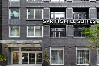 a brick building with a sign that reads spuphill suites at SpringHill Suites by Marriott New York Midtown Manhattan/Park Ave in New York