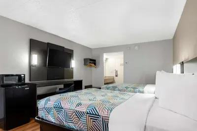 a hotel room with two beds and a flat screen tv at Motel 6-York, PA - North in York
