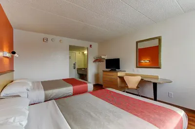 a hotel room with two beds and a desk at Motel 6-York, PA - North in York