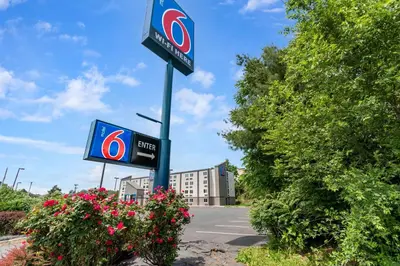 a sign for a gas station in front of a building at Motel 6-York, PA - North in York