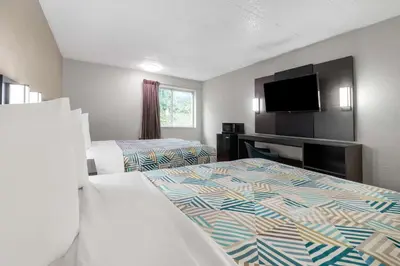 a hotel room with two beds and a flat screen tv at Motel 6-York, PA - North in York