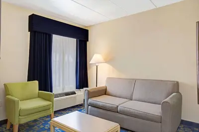 a living room with a couch and two chairs at Windsor Hotel in East Windsor